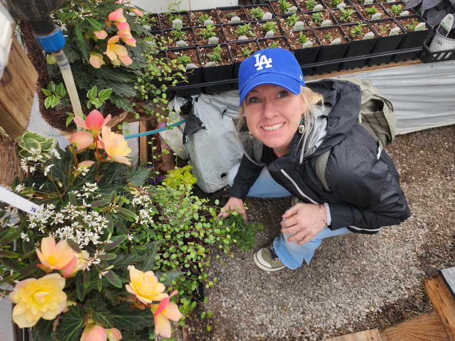 Kelly tending seedlings in a garden nursery